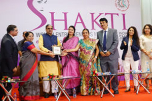 Smt Meena Kaviya, Proprietor, Ayma Creations receiving her trophy by Shri Haribhai P. Chaudhary, MOS, MSME & Dr. Nirmla Sunil Wadhwani, Hon'ble Minister of State for Women & Child Development, Govt of Gujarat